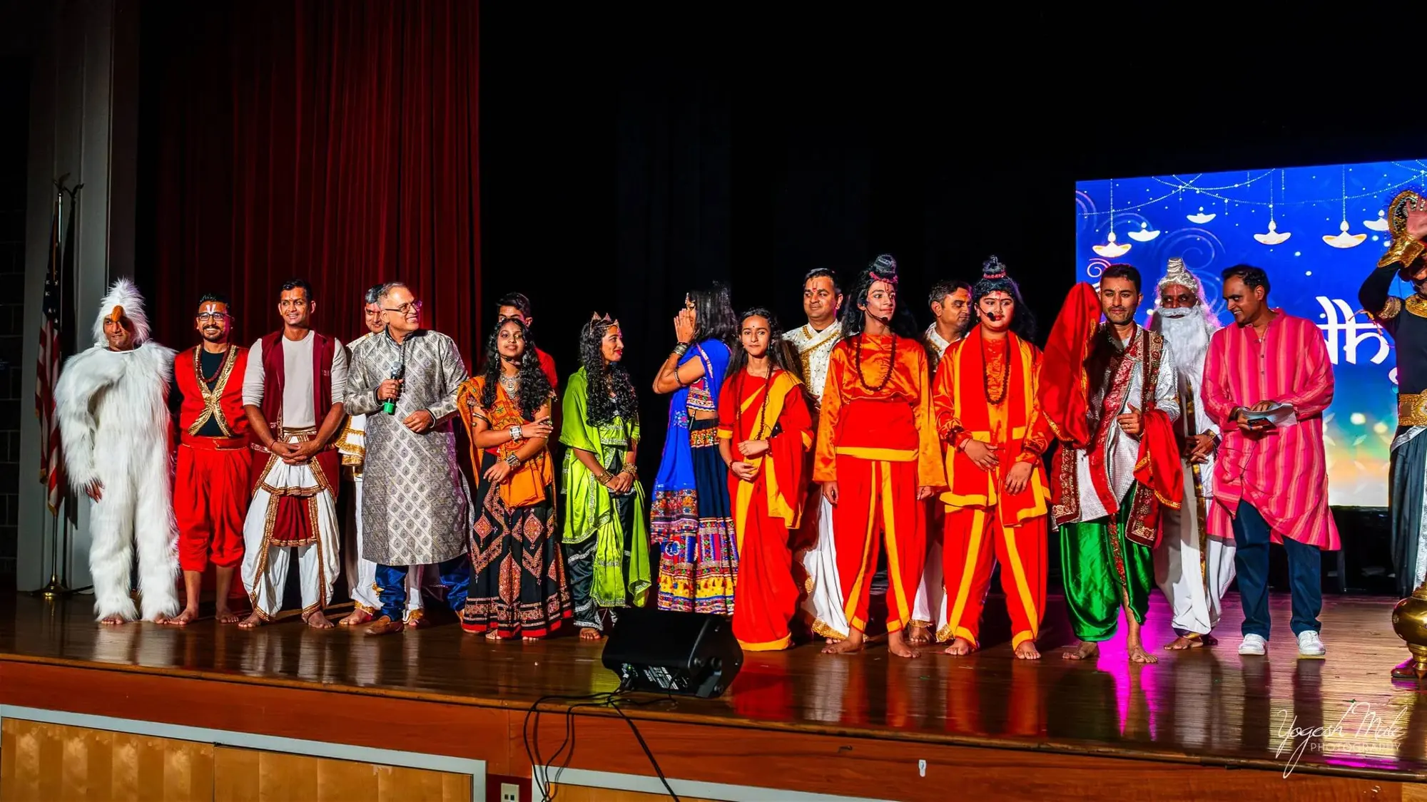 The full cast of the Diwali cultural show lines the stage in costume