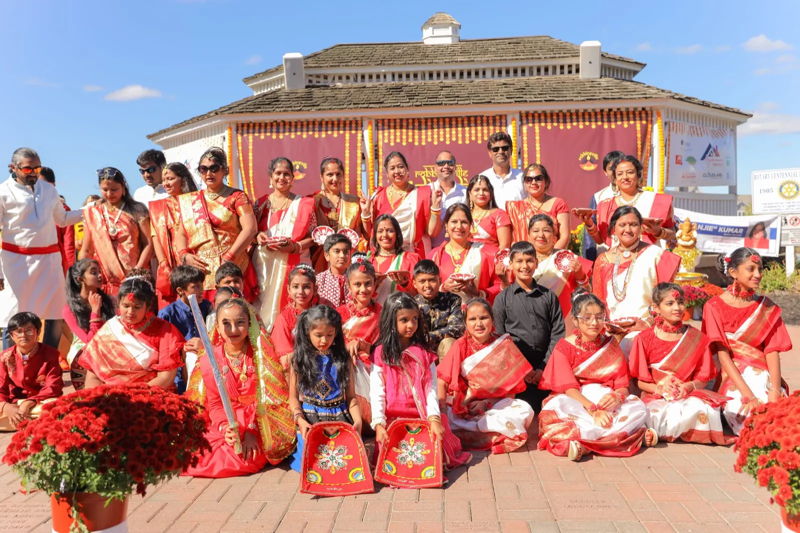 Families in festive Indian dress pose together on the brick plaza at the Robbinsville Diwali celebration