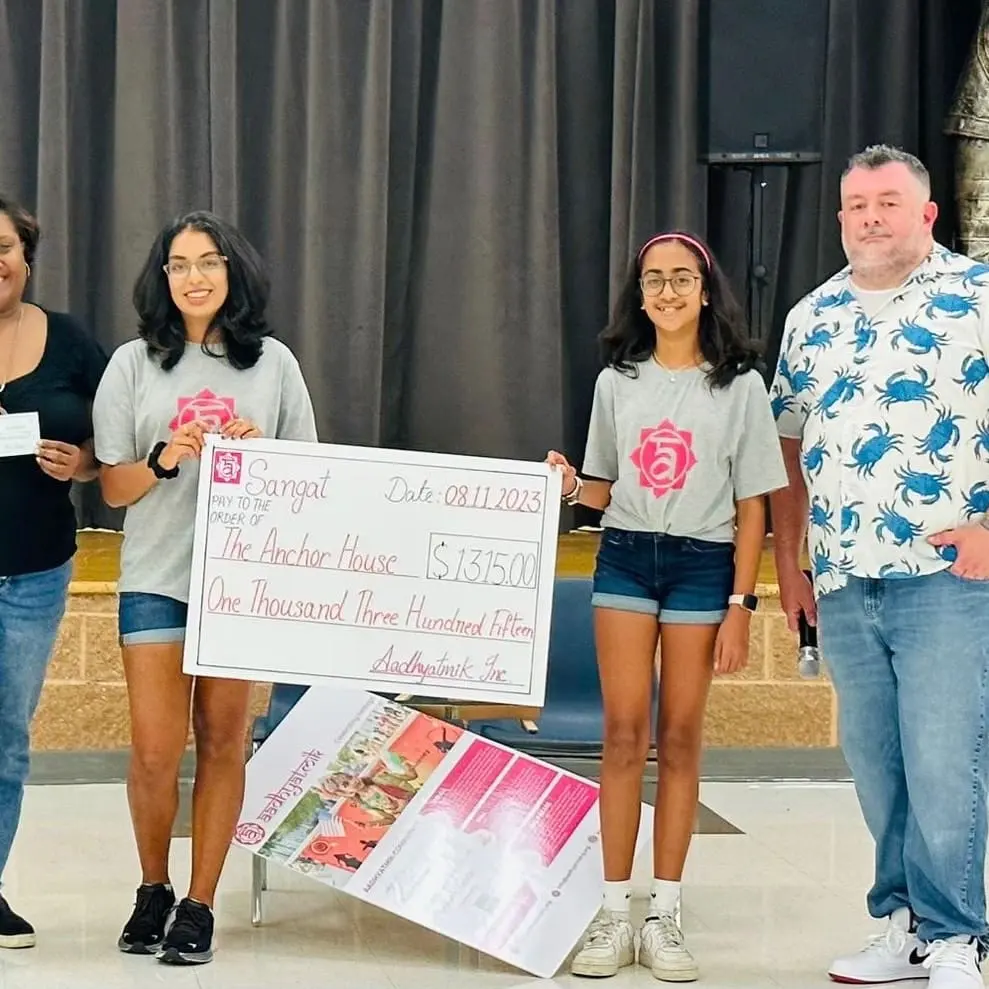 Youth leaders present a donation cheque for a local charity