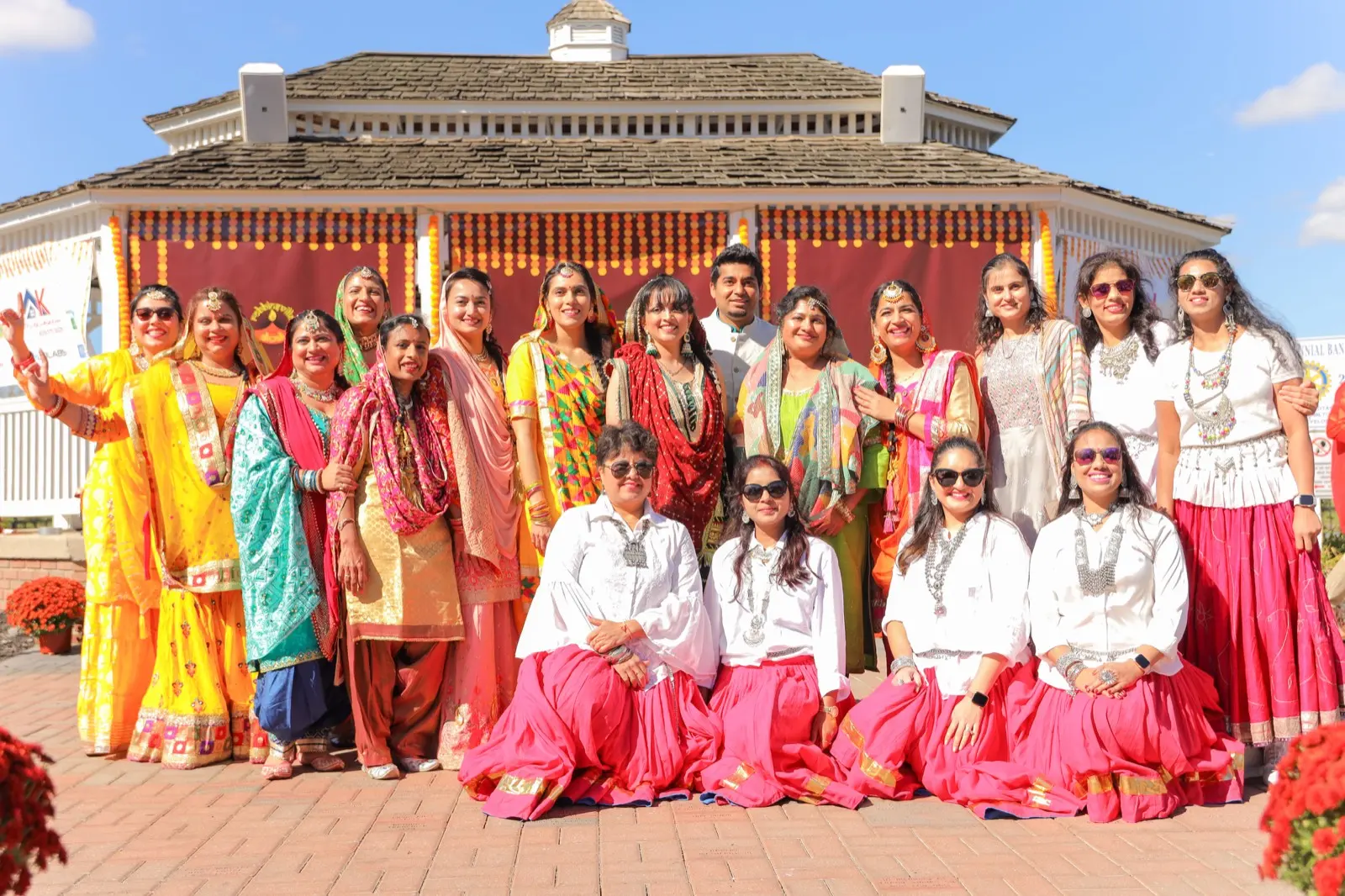 Dozens of parade participants in red and gold saris gathered in front of the decorated Robbinsville Town Center gazebo