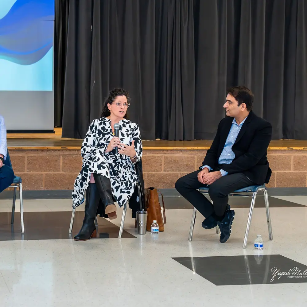 Two panelists in a seated conversation at Sangat