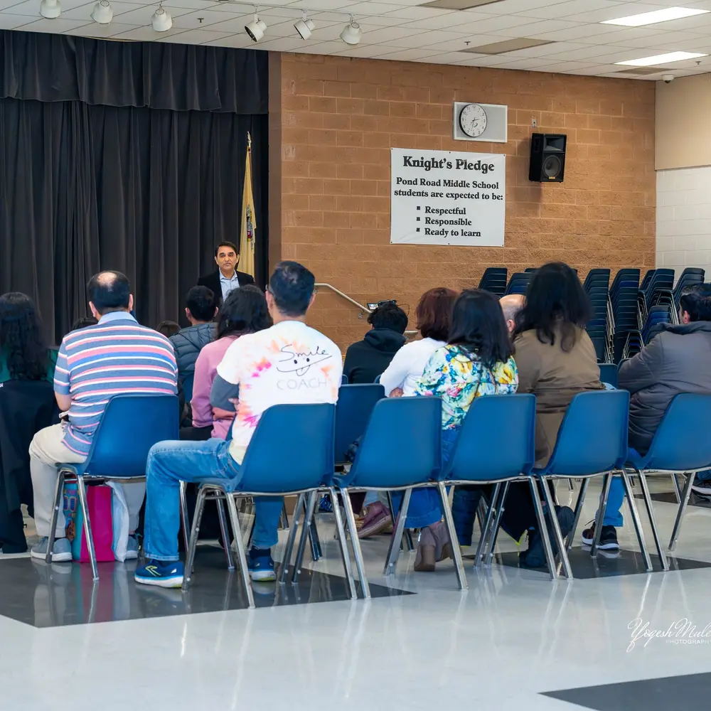 A speaker addresses the audience at a Sangat community conversation