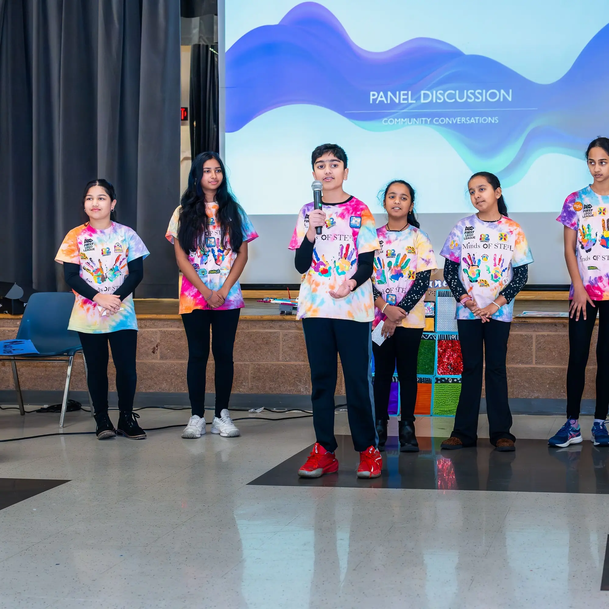 Students line up on stage for a Sangat youth panel