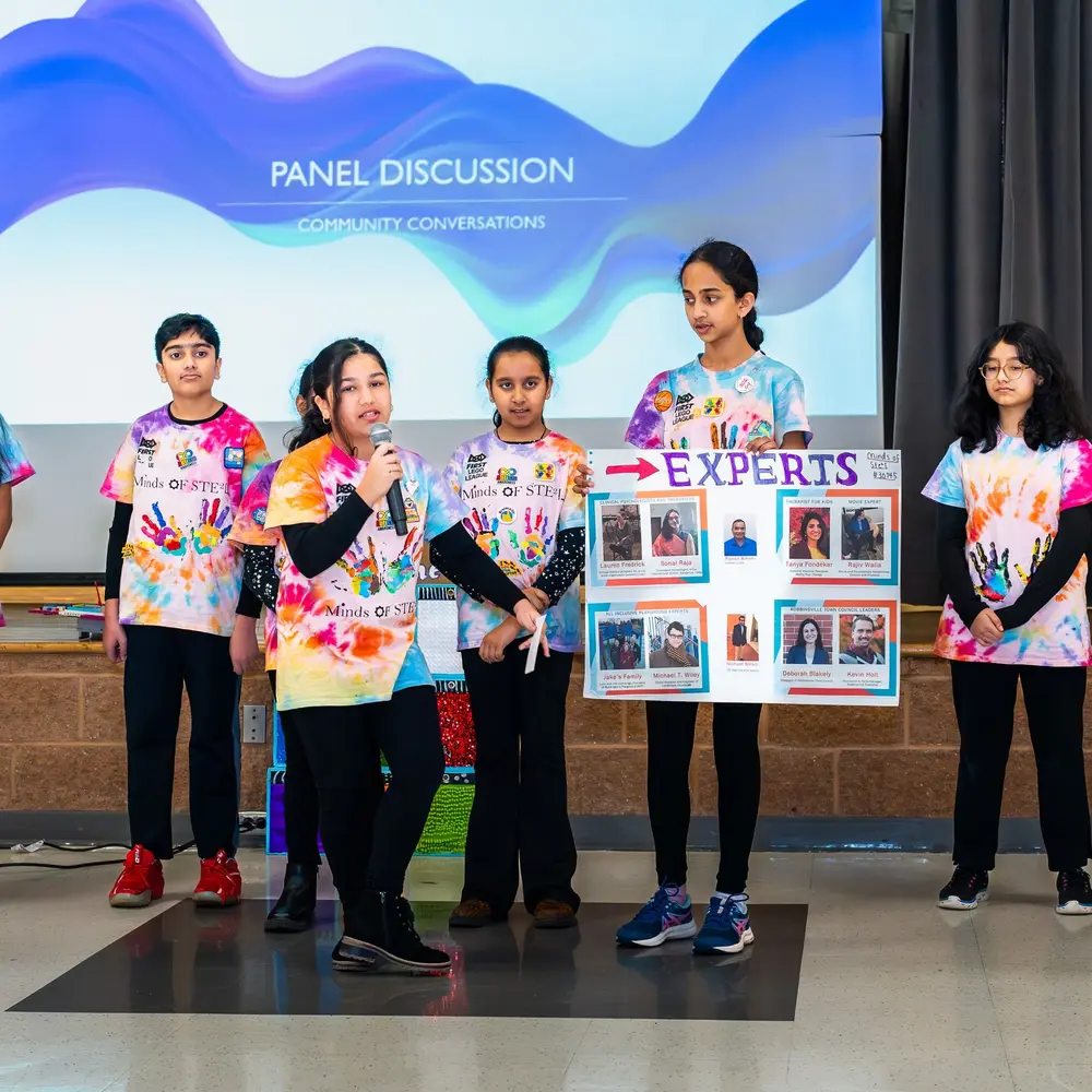 Students present their experts board to the audience at a Sangat panel