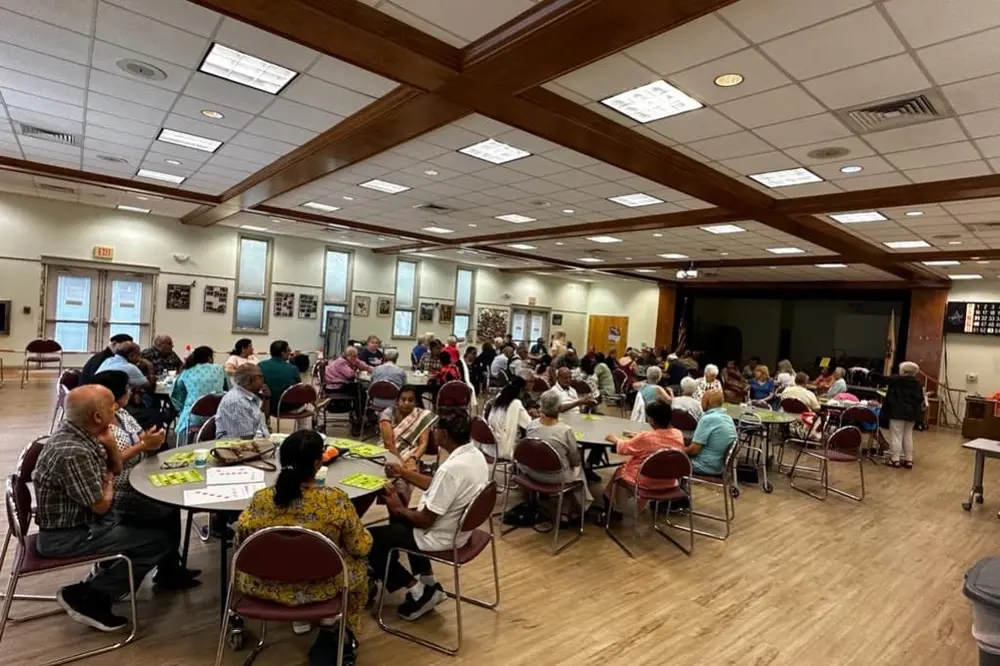 Seniors seated in a hall for a Sanskriti event