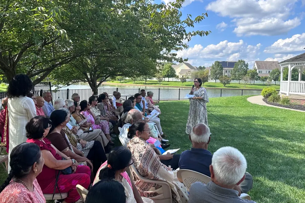 Seniors gathered by the Town Center lake gazebo for a Sanskriti summer social